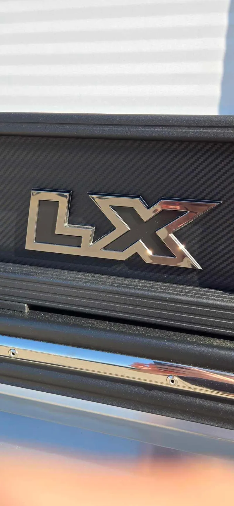 Slide: The Image of 2025 Manitou 25 LX SRW logo on textured surface, close-up view. - 18