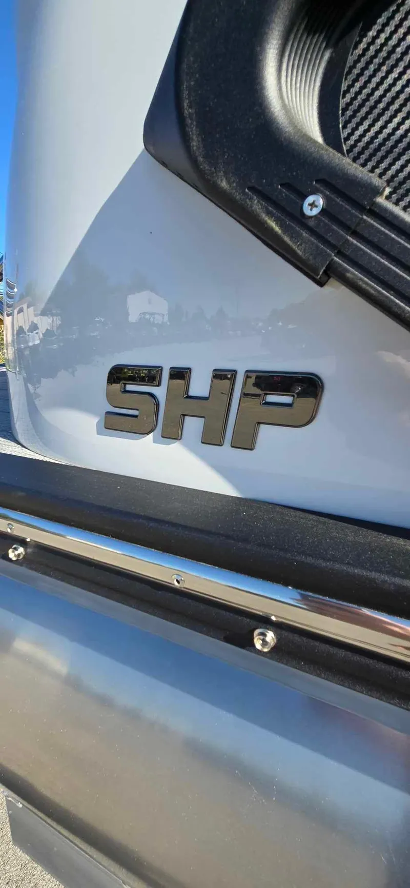 Slide: The Image of 2025 Manitou 25 LX SRW boat with SHP logo detail. - 20