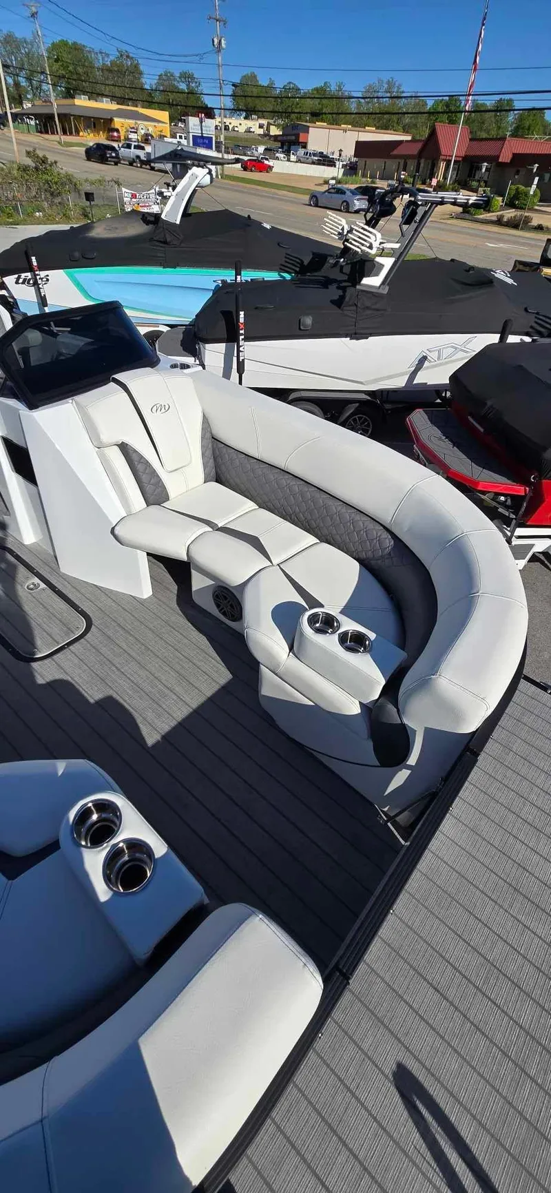 Slide: The Image of 2025 Manitou 25 LX SRW pontoon boat with luxurious seating and cup holders. - 24