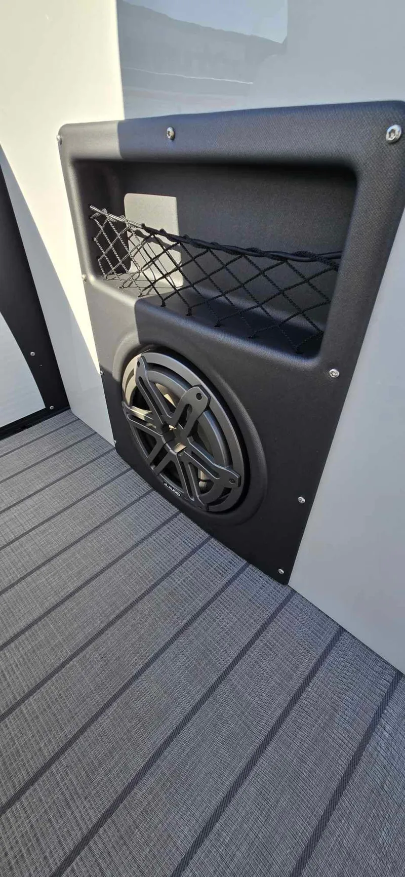 Slide: The Image of Speaker and storage compartment on 2025 Manitou 25 LX SRW boat. - 26