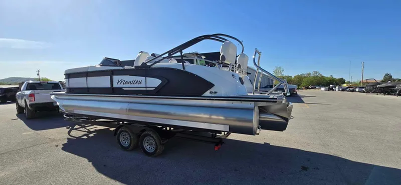 Slide: The Image of 2025 Manitou 25 LX SRW pontoon boat on trailer in parking lot. - 7