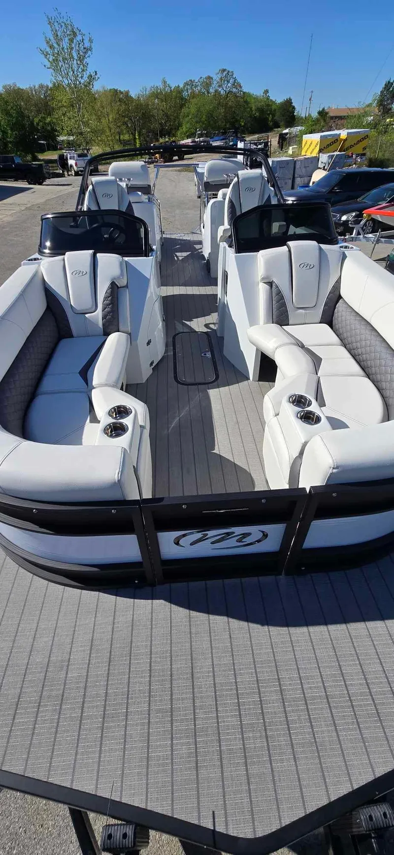 Slide: The Image of 2025 Manitou 25 LX SRW pontoon boat with luxurious seating and sleek design. - 9