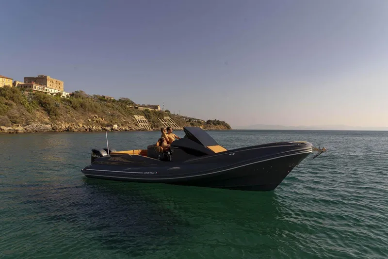 Slide: The Image of 2025 Zar Formenti 95 SL luxury boat cruising near a scenic coastline. - 11