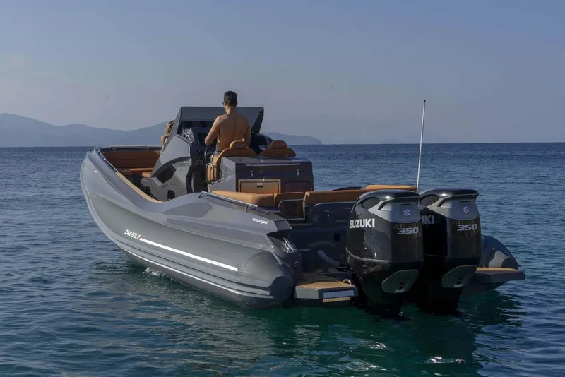 Slide: The Image of 2025 Zar Formenti 95 SL boat with dual Suzuki 350 engines on the water. - 12