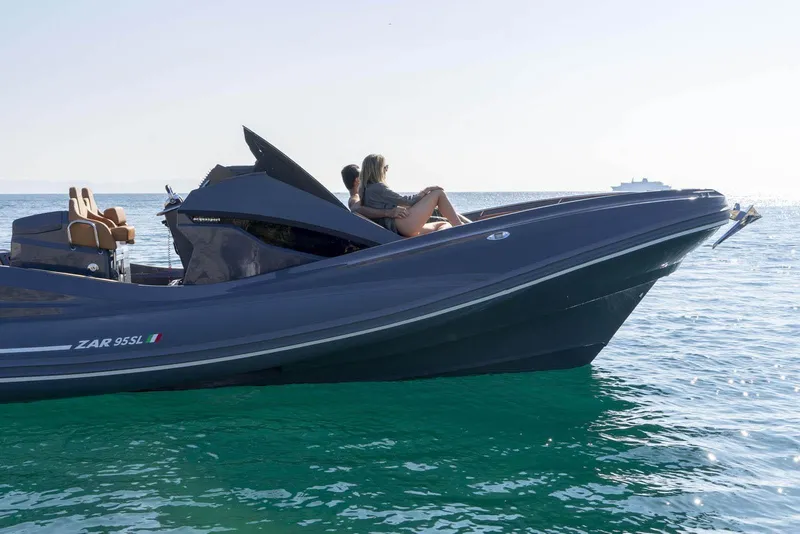 Slide: The Image of 2025 Zar Formenti 95 SL luxury boat cruising on clear blue water. - 13