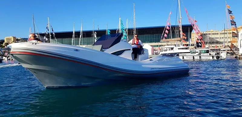 Slide: The Image of 2025 Zar Formenti 95 SL boat on water at marina with flags and buildings. - 5