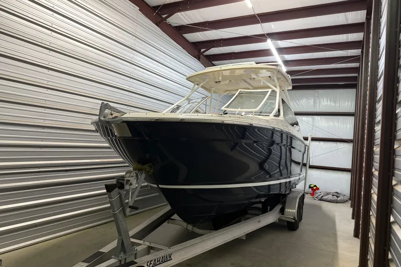 Slide: The Image of 2020 Cutwater C-24 DC boat on trailer in storage facility. - 0