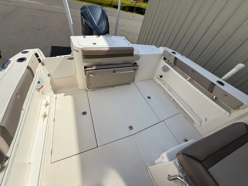 Slide: The Image of 2020 Cutwater C-24 DC boat interior with helm, sink, and seating area. - 14