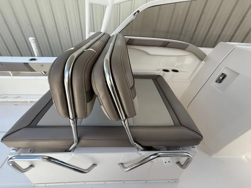 Slide: The Image of 2020 Cutwater C-24 DC boat interior with cushioned seating and cup holders. - 16