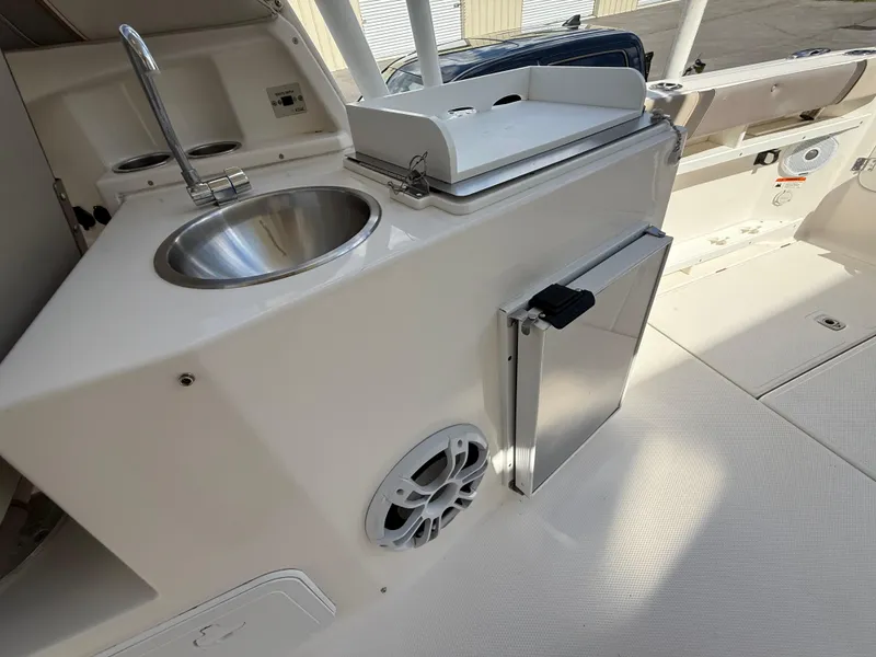 Slide: The Image of 2020 Cutwater C-24 DC boat interior with cushioned seating and speakers. - 18