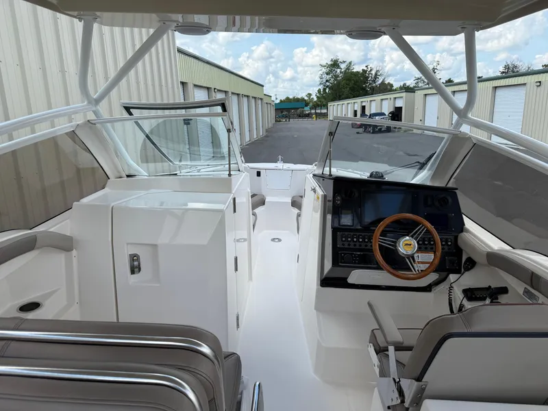 Slide: The Image of 2020 Cutwater C-24 DC boat docked, featuring Yamaha 300 engine and blue underwater lights. - 19