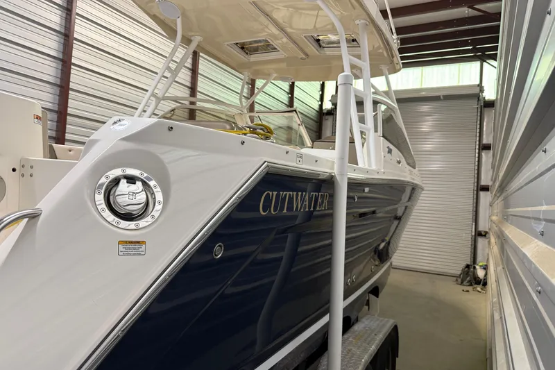 Slide: The Image of 2020 Cutwater C-24 DC boat on trailer, parked outdoors, side view. - 2