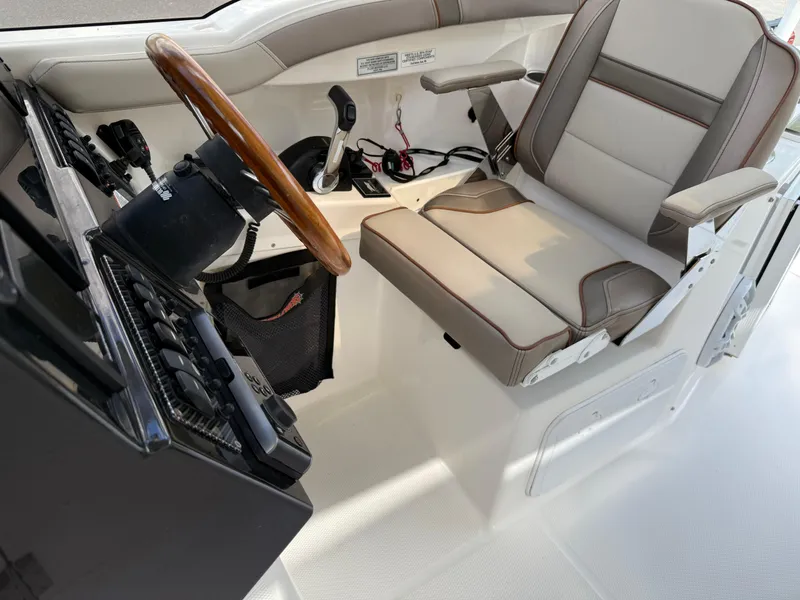 Slide: The Image of 2020 Cutwater C-24 DC boat interior with illuminated dashboard and seating. - 21