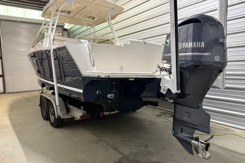 Slide: The Image of 2020 Cutwater C-24 DC boat in storage, side view with visible branding. - 3