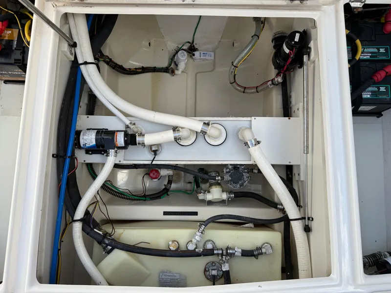 Slide: The Image of 2020 Cutwater C-24 DC boat in storage, illuminated by blue lights. - 32