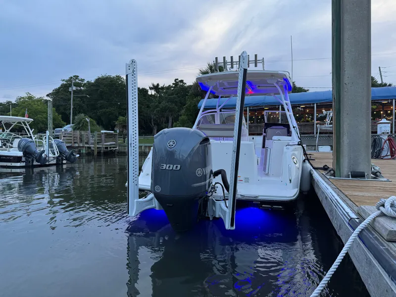Slide: The Image of 2020 Cutwater C-24 DC boat interior in storage, showing clean white surfaces and warning labels. - 37