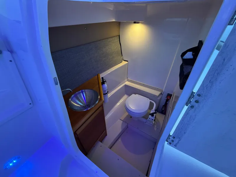 Slide: The Image of Close-up of a 2020 Cutwater C-24 DC boat propeller in a garage setting. - 39