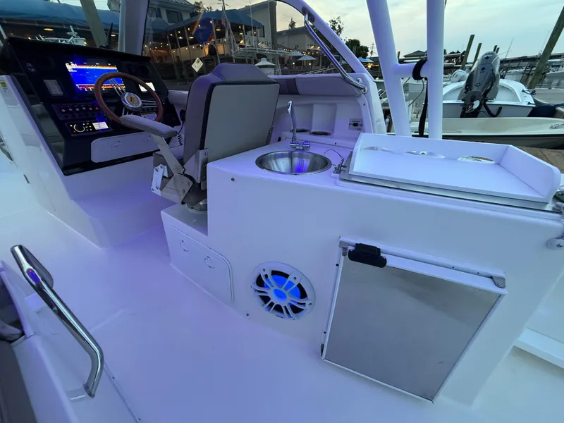 Slide: The Image of 2020 Cutwater C-24 DC boat anchor compartment with rope and metal fittings. - 41