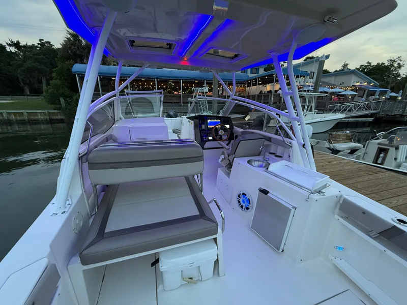 Slide: The Image of 2020 Cutwater C-24 DC boat in storage, blue exterior, with maintenance equipment nearby. - 43