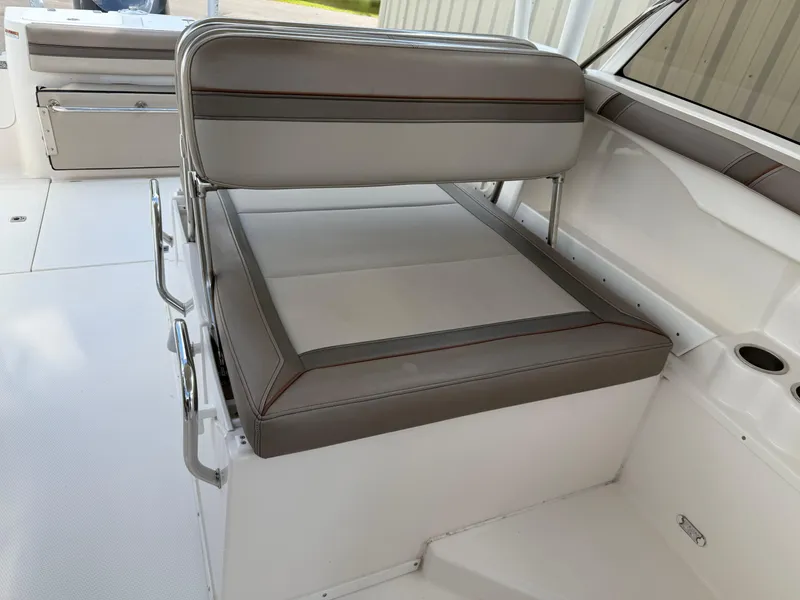 Slide: The Image of 2020 Cutwater C-24 DC helm with steering wheel, captain's chair, and control panel. - 44