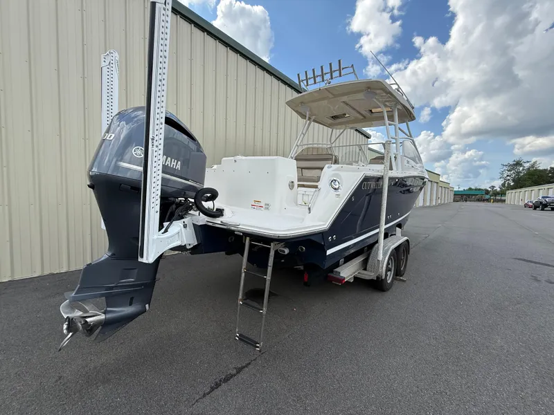 Slide: The Image of 2020 Cutwater C-24 DC boat stored in a metal garage on a trailer. - 46