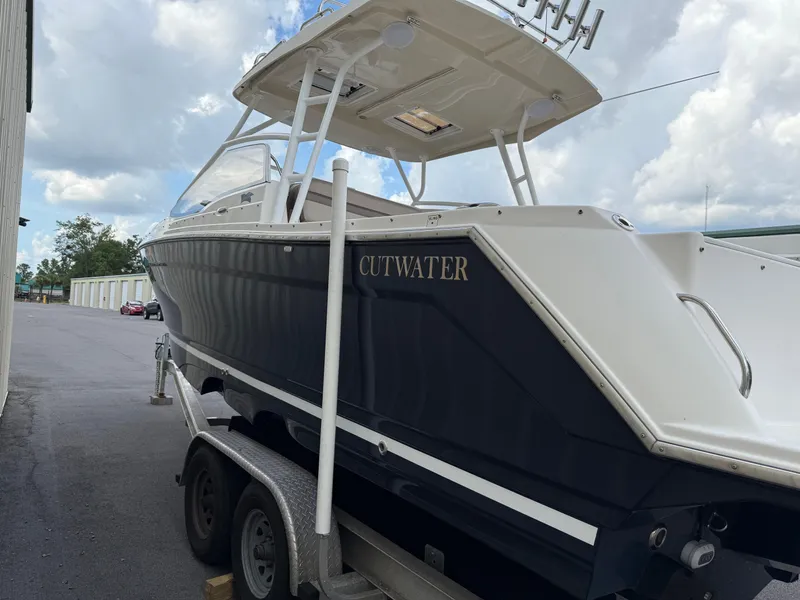 Slide: The Image of 2020 Cutwater C-24 DC boat stored indoors, featuring a sleek design and protective cover. - 47