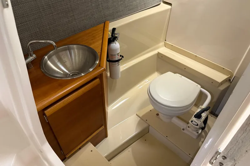 Slide: The Image of 2020 Cutwater C-24 DC boat on trailer, parked near storage units. - 53