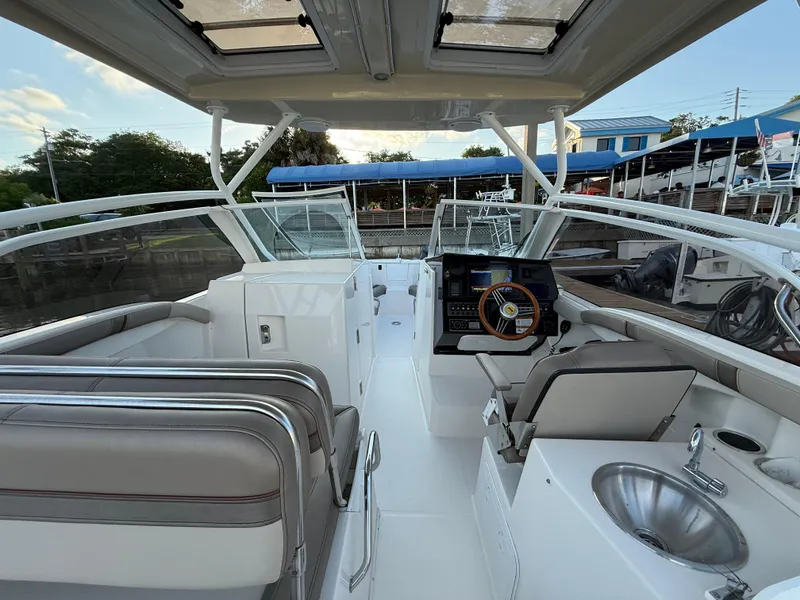 Slide: The Image of 2020 Cutwater C-24 DC boat dashboard with modern controls and wooden steering wheel. - 8