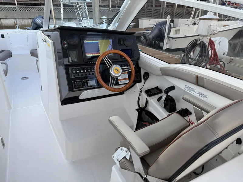 Slide: The Image of 2020 Cutwater C-24 DC boat in storage, featuring spacious seating and Yamaha engine. - 9