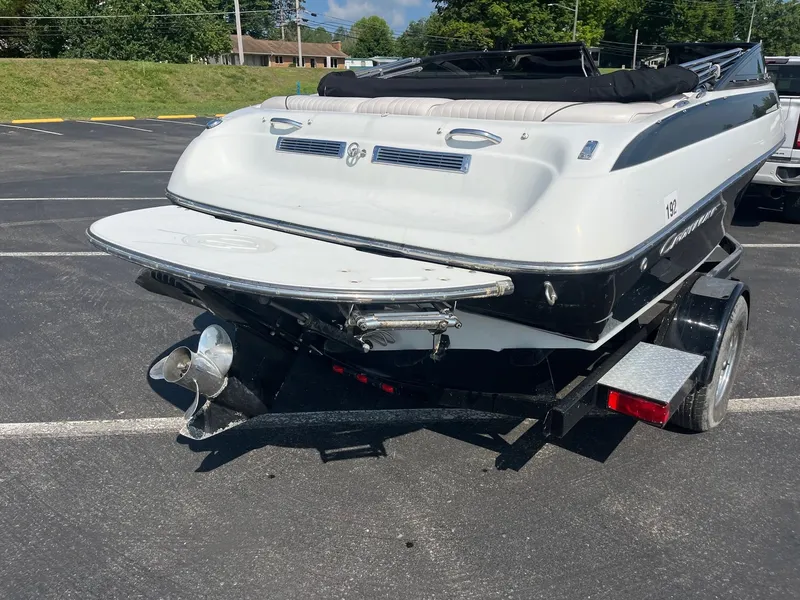Slide: The Image of 2014 Crownline 18 SS boat on trailer, parked in a lot, rear view. - 5
