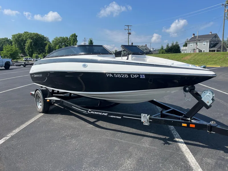 Slide: The Image of 2014 Crownline 18 SS boat on trailer in parking lot, sunny day. - 6