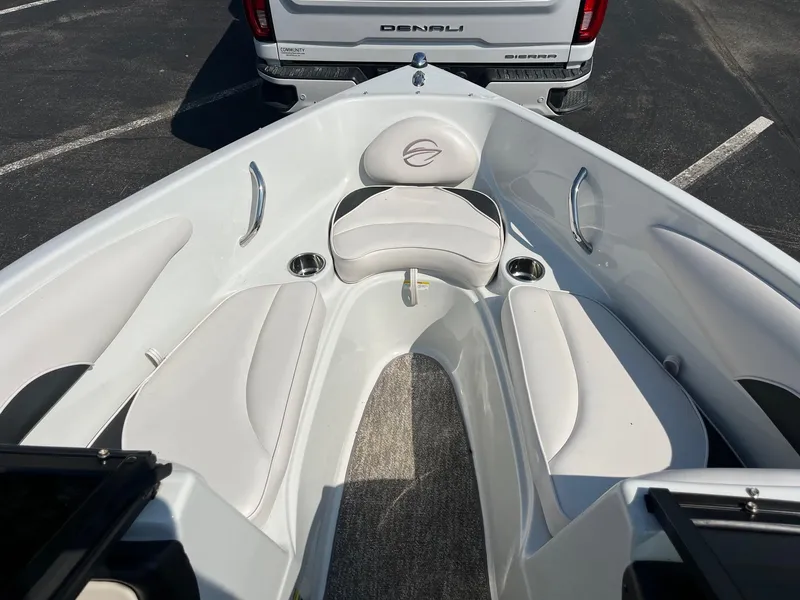 Slide: The Image of 2014 Crownline 18 SS boat interior with white seating and cup holders. - 7