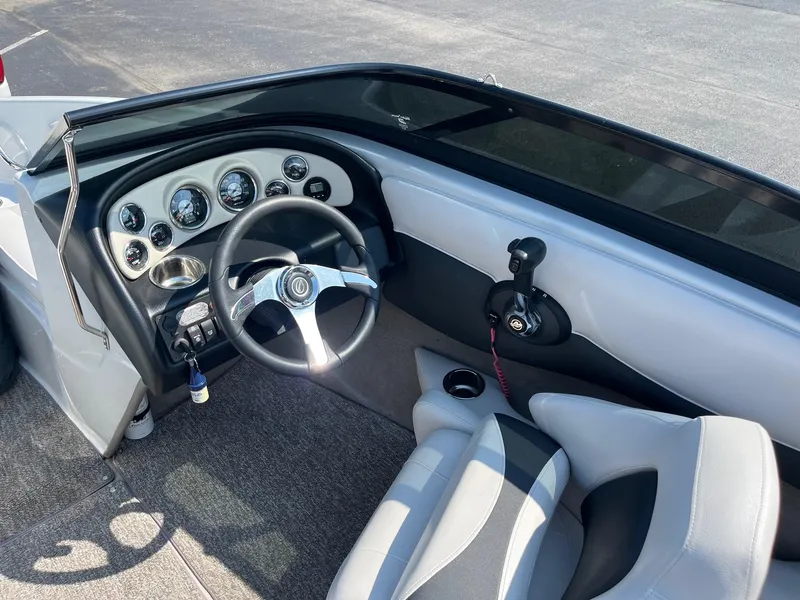 Slide: The Image of 2014 Crownline 18 SS boat interior with steering wheel and dashboard controls. - 9