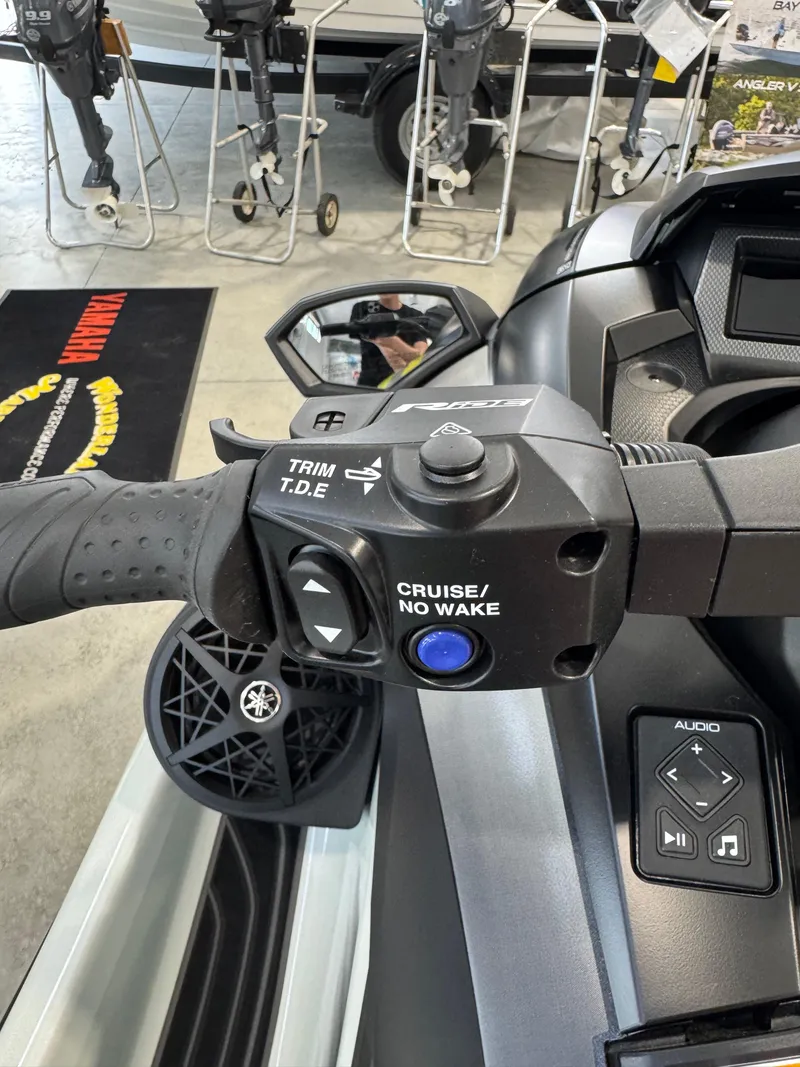 Slide: The Image of 2025 Yamaha WaveRunner GP HO handlebar controls with audio system in showroom. - 9