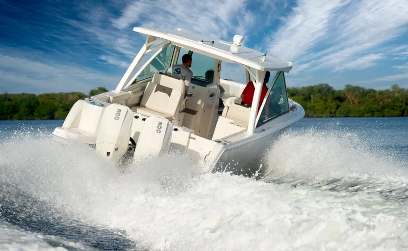 Slide: The Image of 2025 Sailfish 316 DC boat cruising on water, creating a dynamic wake. - 15