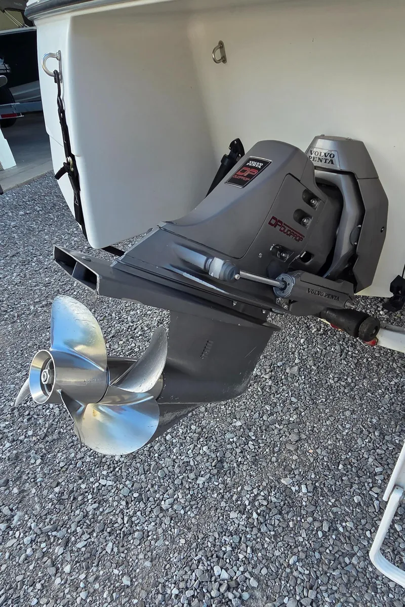 Slide: The Image of 1995 Four Winns 245 Sundowner boat with Volvo Penta outdrive on gravel surface. - 10