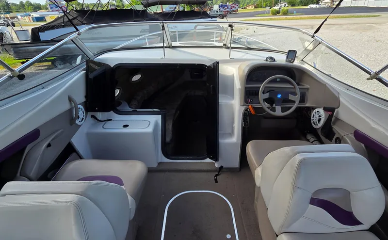 Slide: The Image of 1995 Four Winns 245 Sundowner boat interior with steering wheel and seating. - 4