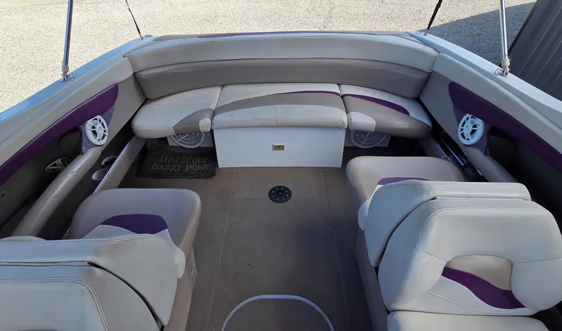 Slide: The Image of 1995 Four Winns 245 Sundowner boat interior with beige and purple seating, spacious layout. - 5