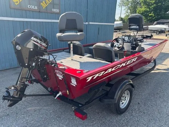 Slide: The Image of 2024 Tracker Pro 170 boat with Mercury engine, red exterior, parked outdoors. - 2