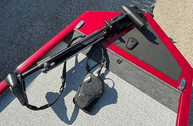 Slide: The Image of 2024 Tracker Pro 170 boat deck with trolling motor and foot pedal, featuring red and gray design. - 7