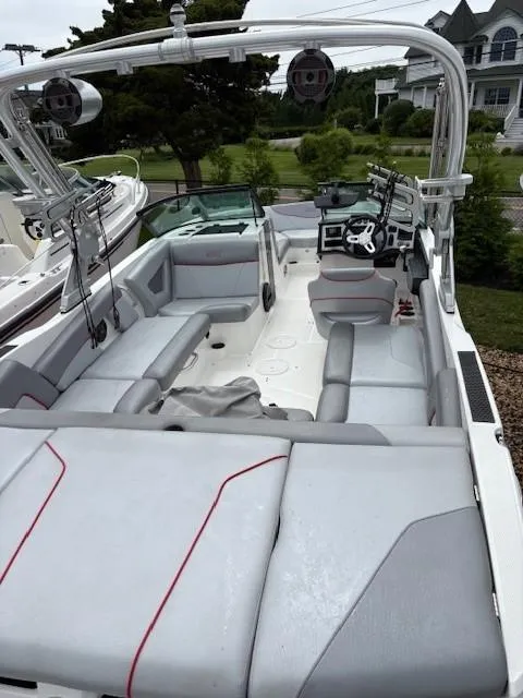 Slide: The Image of 2019 MasterCraft NXT22 boat with spacious seating and modern dashboard. - 12