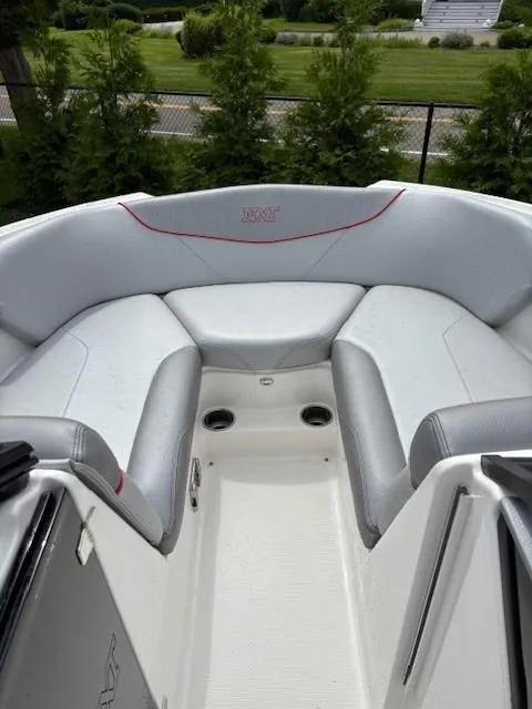 Slide: The Image of 2019 MasterCraft NXT22 boat interior with gray seating and cup holders. - 13