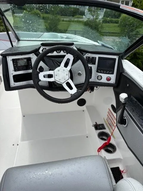 Slide: The Image of 2019 MasterCraft NXT22 boat dashboard with steering wheel and control panel. - 2