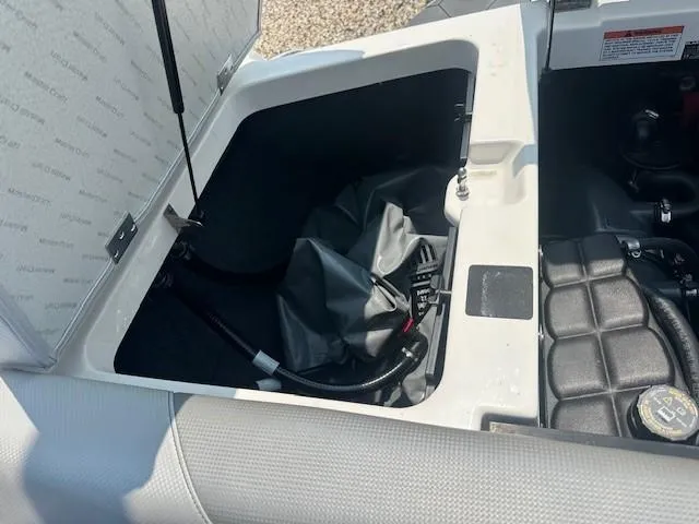 Slide: The Image of Open engine compartment of 2019 MasterCraft NXT22 boat, showing storage and mechanical components. - 3