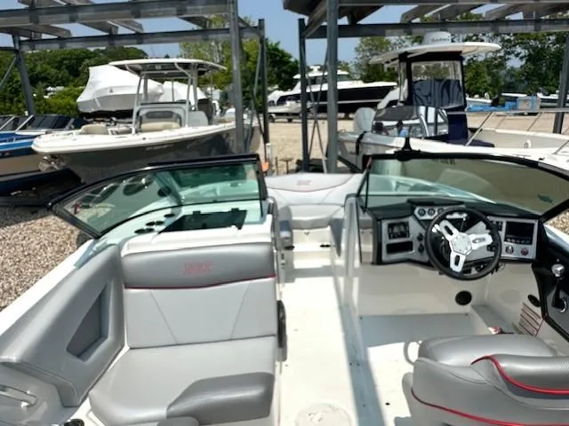 Slide: The Image of 2019 MasterCraft NXT22 boat interior with gray seating and modern dashboard. - 7