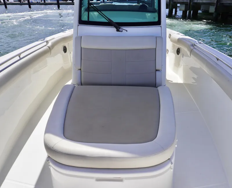 Slide: The Image of 2021 Boston Whaler 330 Outrage boat interior with cushioned seating. - 11