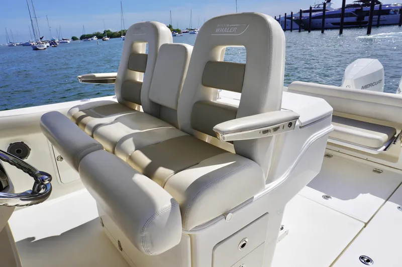 Slide: The Image of 2021 Boston Whaler 330 Outrage boat interior with luxurious seating and ocean view. - 14