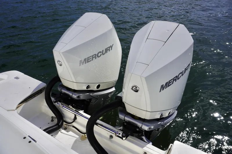 Slide: The Image of Twin Mercury outboard engines on a 2021 Boston Whaler 330 Outrage boat. - 16