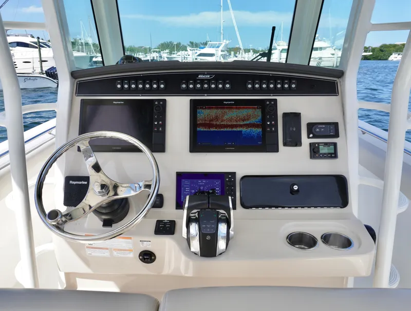 Slide: The Image of 2021 Boston Whaler 330 Outrage helm with advanced navigation and control systems. - 18