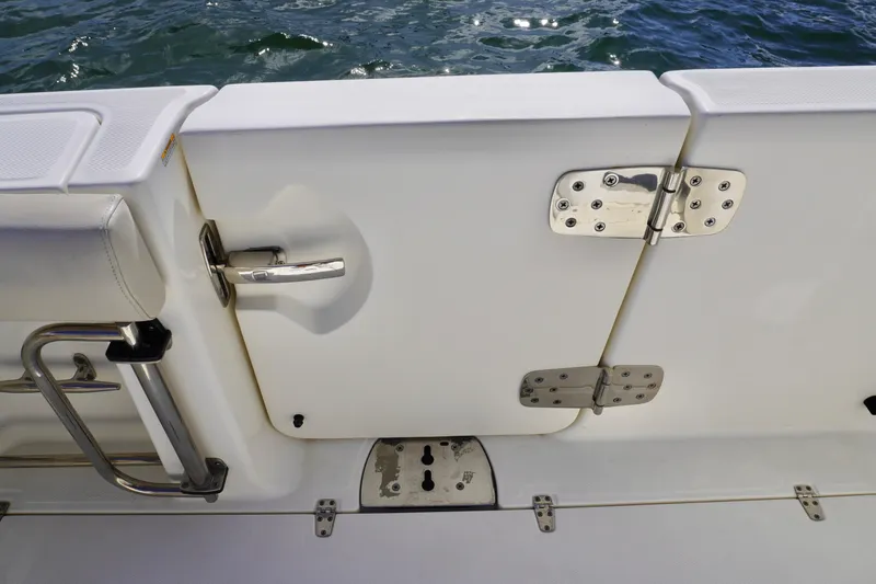 Slide: The Image of Boston Whaler 330 Outrage 2021 boat door with stainless steel hinges and handle. - 22